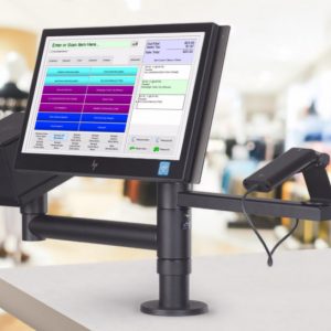 Touchscreen point-of-sale display mounted on a vertical pole at a store counter, showing a colorful interface.