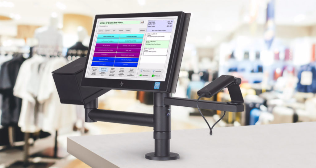 Point-of-sale touchscreen register mounted on a stand at a clothing store, showing a colorful checkout interface.